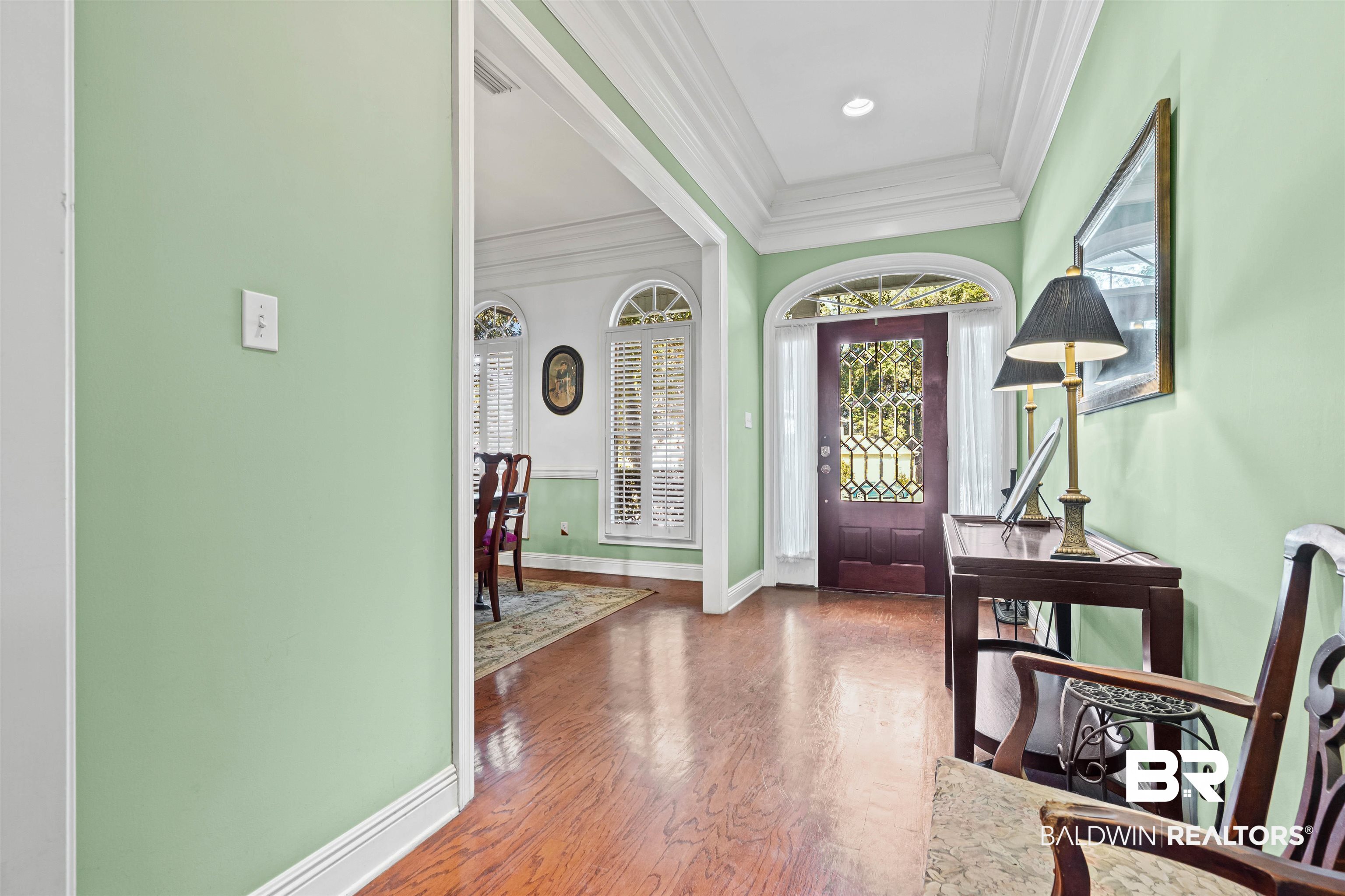 107 Beaver Dam Road Fairhope, AL 36532 - Photo 14 of 45 Foyer entrance featuring crown molding and wood finished floors