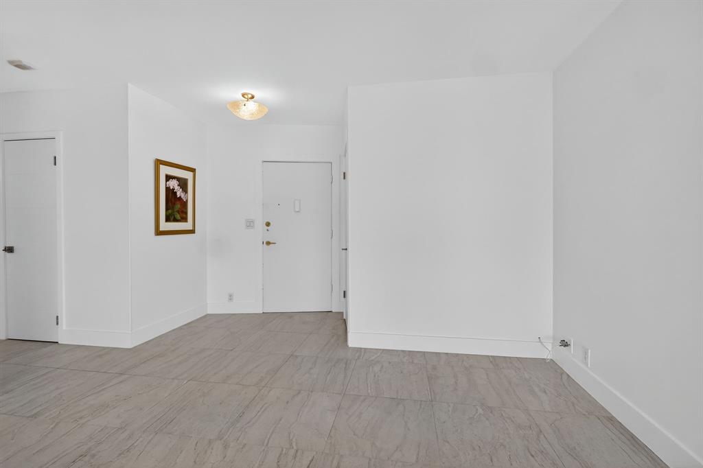 44 Cocoanut Row, Unit 507A Palm Beach, FL 33480 - Photo 11 of 60 an empty room with wooden floor and windows