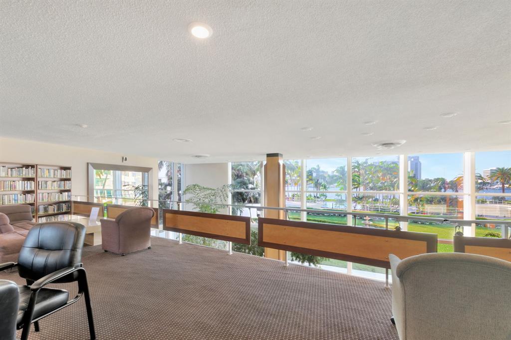 44 Cocoanut Row, Unit 507A Palm Beach, FL 33480 - Photo 51 of 60 a living room with furniture a floor to ceiling window and a flat screen tv