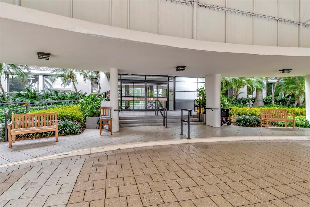 44 Cocoanut Row, Unit 507A Palm Beach, FL 33480 - Photo 58 of 60 a view of a porch with chairs and a yard