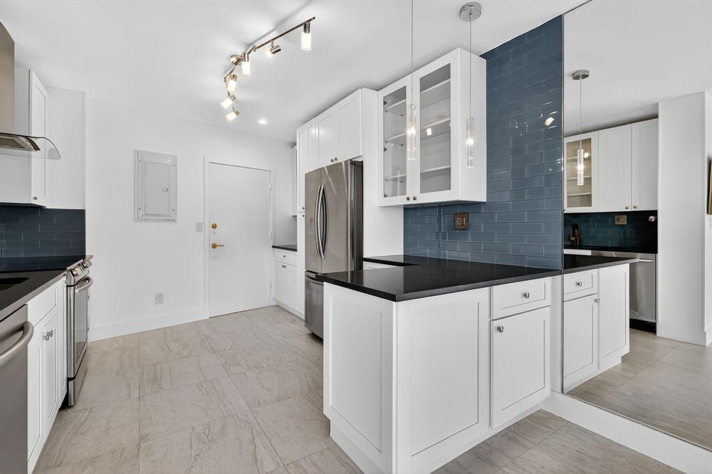 44 Cocoanut Row, Unit 507A Palm Beach, FL 33480 - Photo 6 of 60 a kitchen with granite countertop a refrigerator a sink and white cabinets