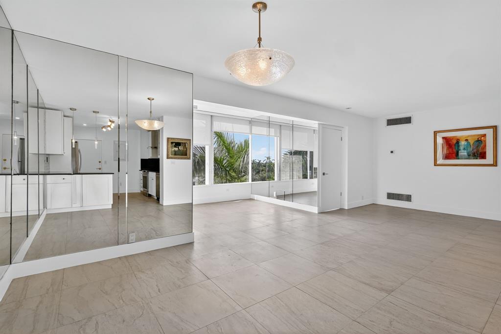 44 Cocoanut Row, Unit 507A Palm Beach, FL 33480 - Photo 7 of 60 a view of an empty room with a fireplace and a chandelier