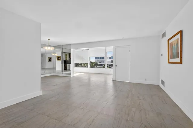 a view of a kitchen with a sink and a refrigerator