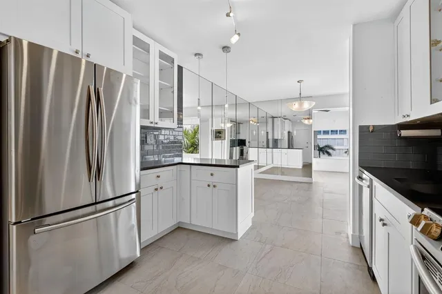 a kitchen with stainless steel appliances a refrigerator sink and cabinets
