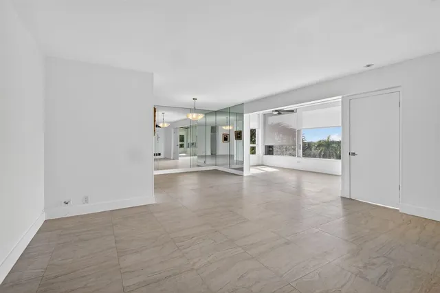 a view of empty room with kitchen