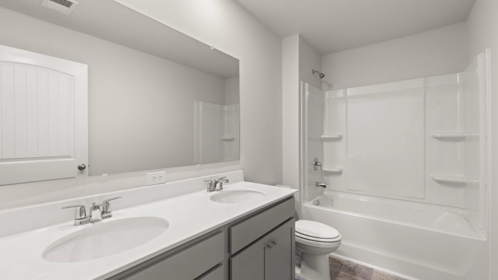 174 Thompson Ridge Lane Dallas, GA 30132 - Photo 28 of 35 a bathroom with a sink toilet and shower