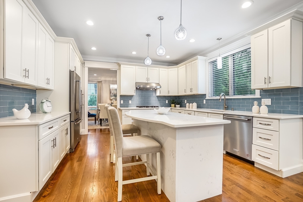57 Walnut Street Newton, MA 02460 - Photo 20 of 39 a kitchen with white cabinets and white appliances