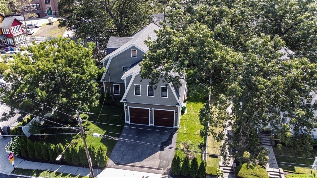 57 Walnut Street Newton, MA 02460 - Photo 2 of 39 a front view of a house with a garden