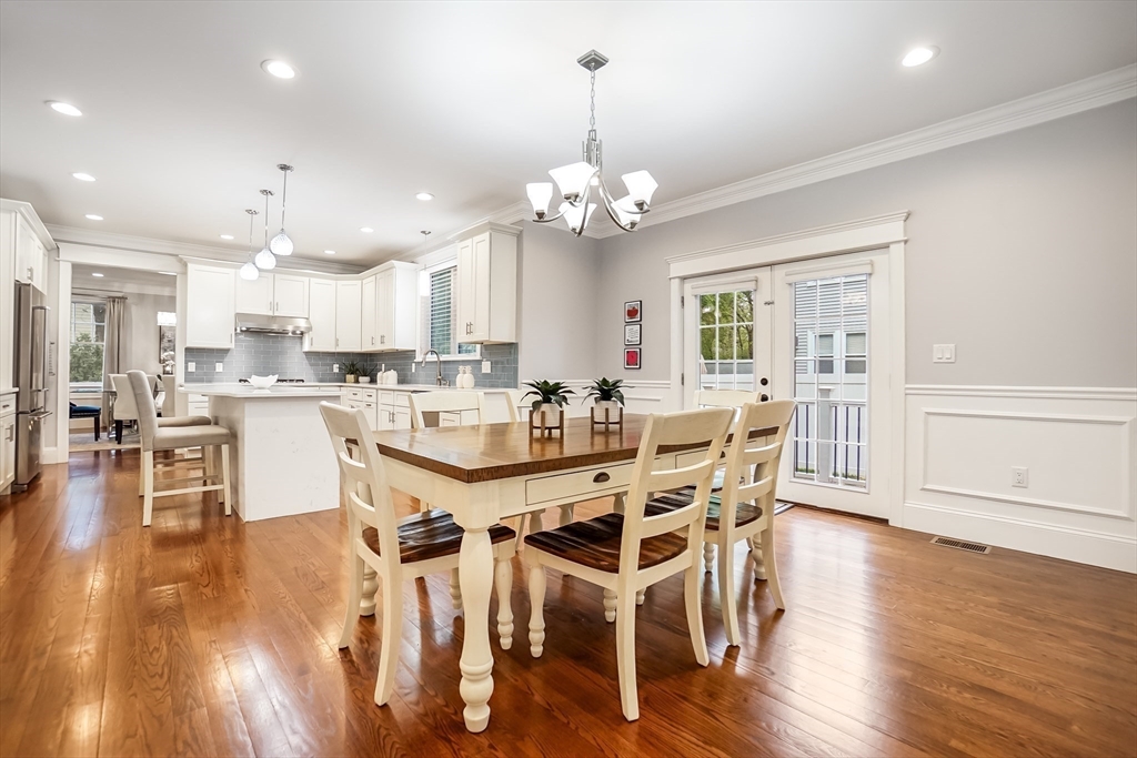 57 Walnut Street Newton, MA 02460 - Photo 22 of 39 a kitchen with stainless steel appliances kitchen island granite countertop a dining table chairs and view living room