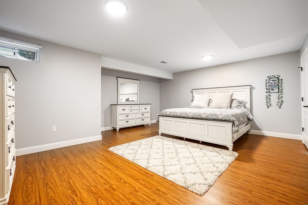 57 Walnut Street Newton, MA 02460 - Photo 34 of 39 a spacious bedroom with a bed and a night stand