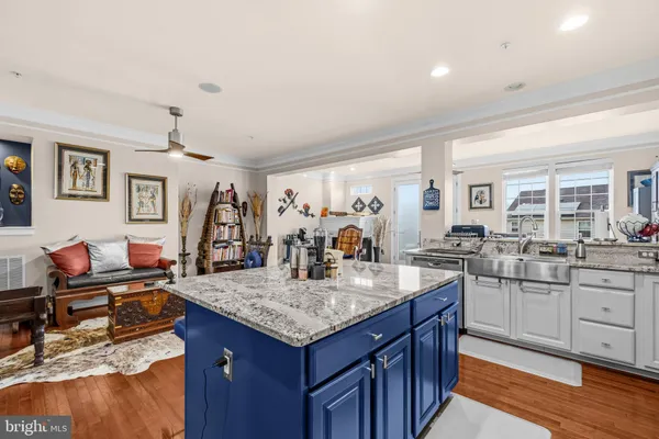 a kitchen with granite countertop a sink and cabinets
