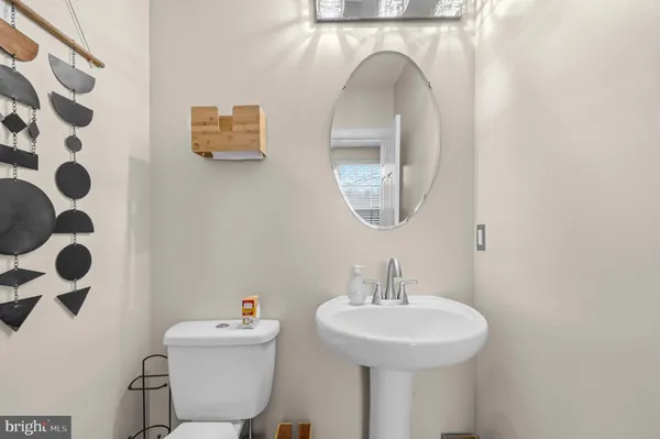 a bathroom with a sink a mirror and a toilet