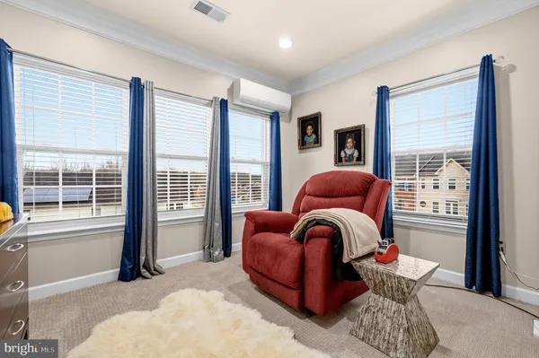 a bedroom with furniture and a large window
