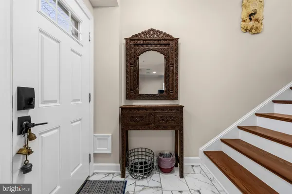 a view of a hallway with wooden floor and a fireplace
