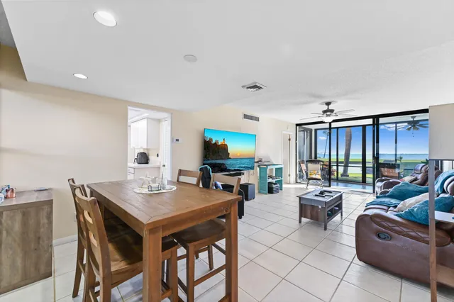 a living room with furniture a flat screen tv and a large window