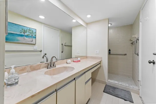 a bathroom with a granite countertop sink mirror and double