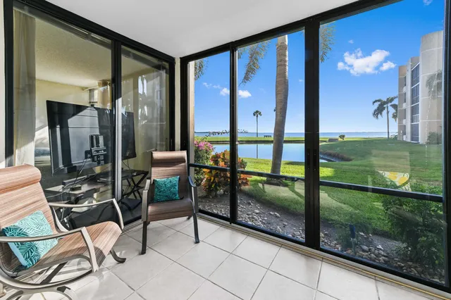 a view of a porch with chairs and backyard