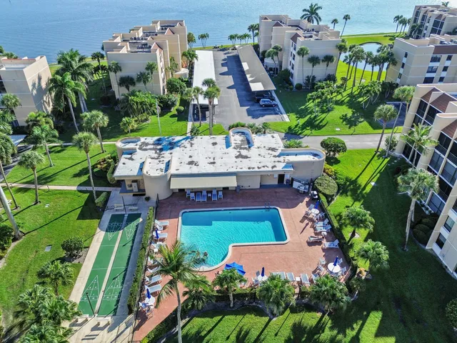 a front view of a house with a yard and potted plants