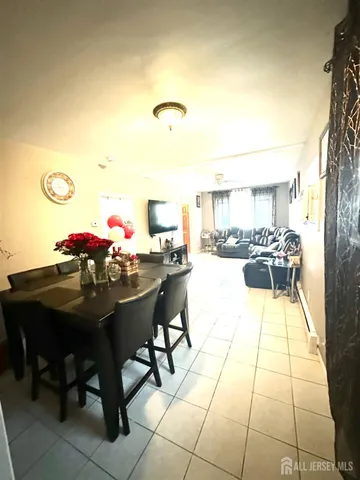 a view of a dining room with furniture and a potted plant