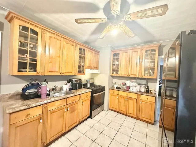 a kitchen with stainless steel appliances a stove sink and cabinets