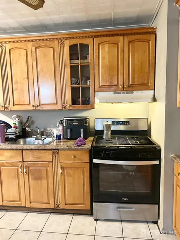 a kitchen with granite countertop white cabinets and window