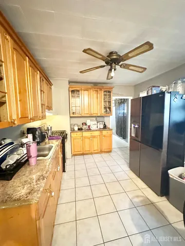 a large kitchen with a large window appliances and cabinets