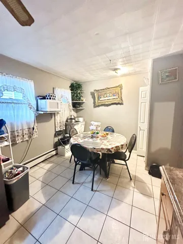 a view of a dining room with a table and chairs