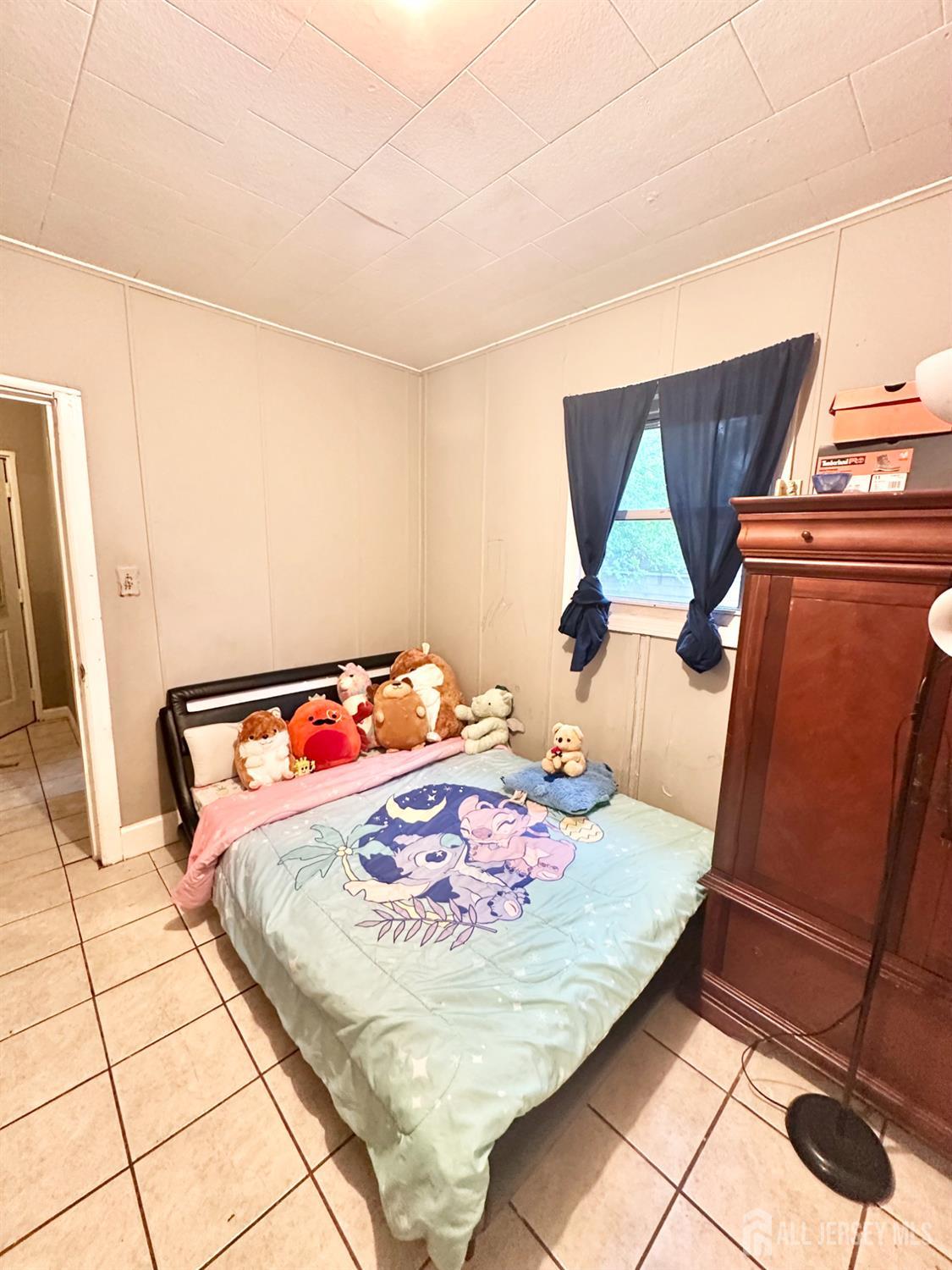 44 South Ward Street New Brunswick, NJ 08901 - Photo 28 of 34 a bedroom with a bed and a dresser
