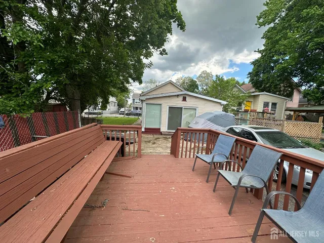 a view of a chairs and table on the wooden deck