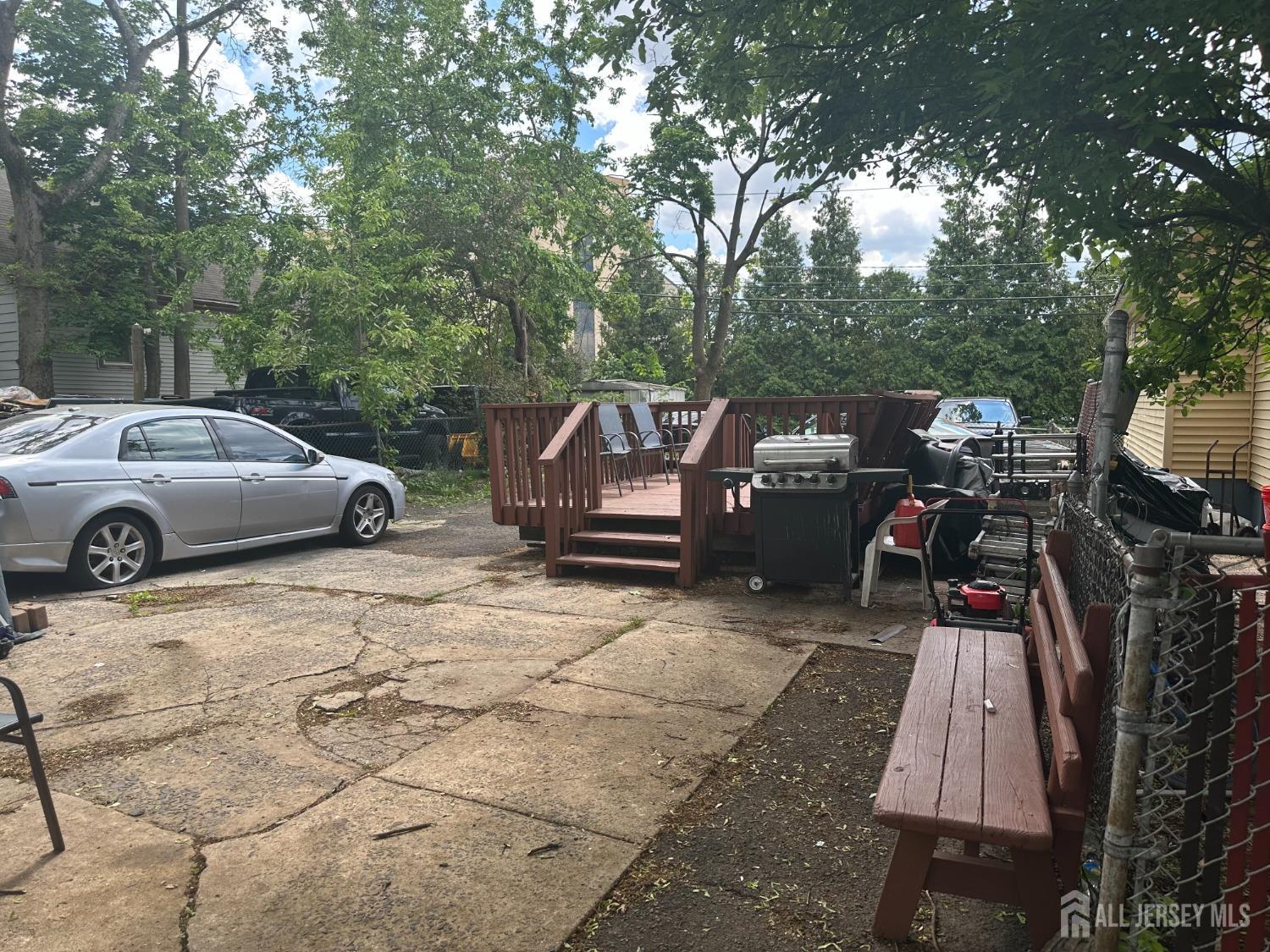 44 South Ward Street New Brunswick, NJ 08901 - Photo 10 of 34 a view of a patio with table and chairs with wooden floor and fence