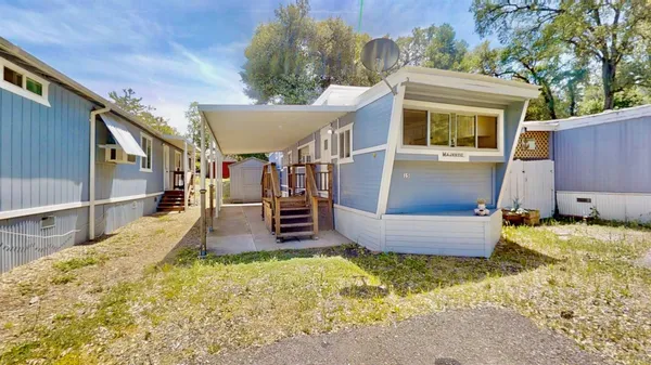 a view of a house with backyard and sitting area