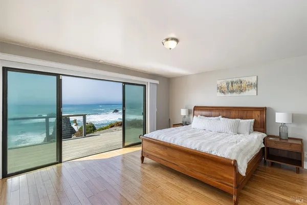 a bedroom with a bed and large window