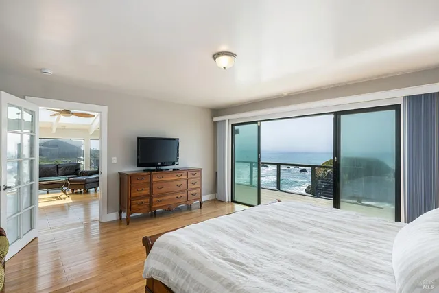 a bedroom with a bed and large window