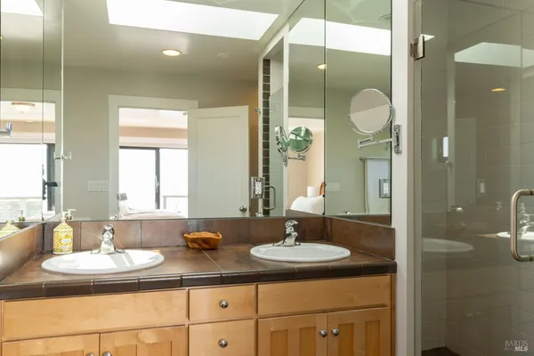 a bathroom with a sink double vanity and a mirror