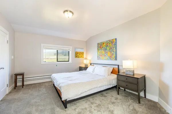 a bedroom with a bed and a window