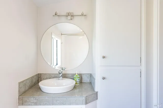 a bathroom with a sink a mirror and a toilet