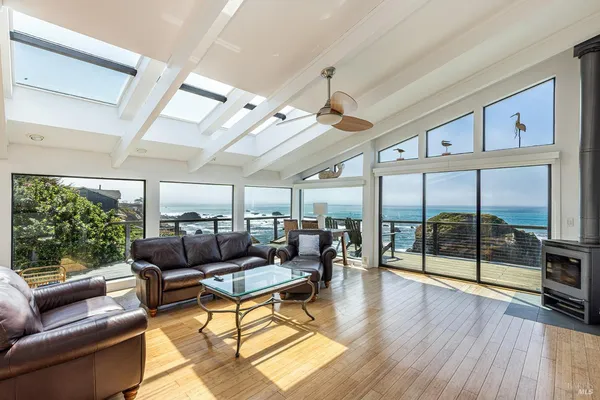 a living room with furniture and a floor to ceiling window