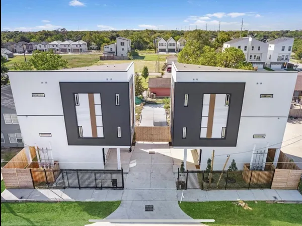 an aerial view of a house with a yard