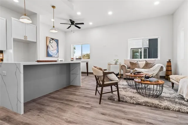 a kitchen with kitchen island a white counter top space cabinets and stainless steel appliances