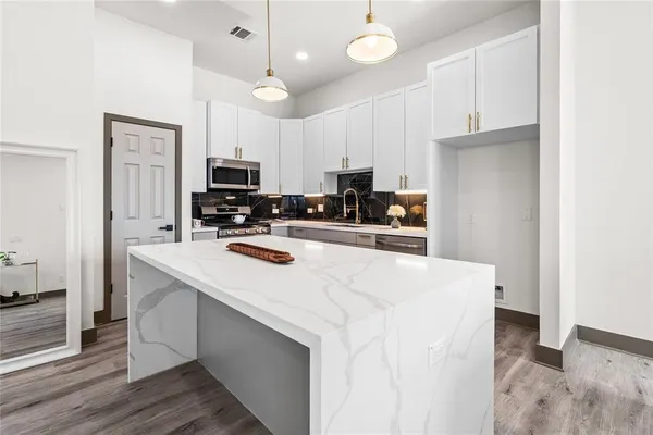 a kitchen with a sink stove and microwave