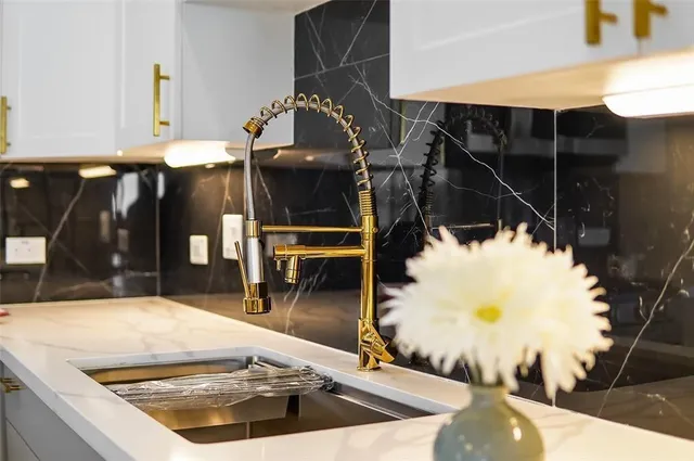 a view of a kitchen with wooden floor and electronic appliances