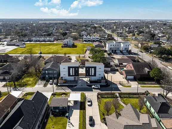 an aerial view of residential houses with outdoor space and swimming pool