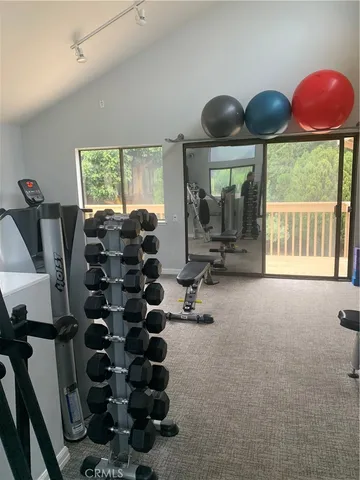 a room with lots of windows and furniture