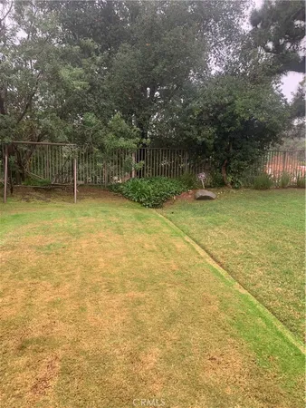 a backyard of a house with lots of green space and trees