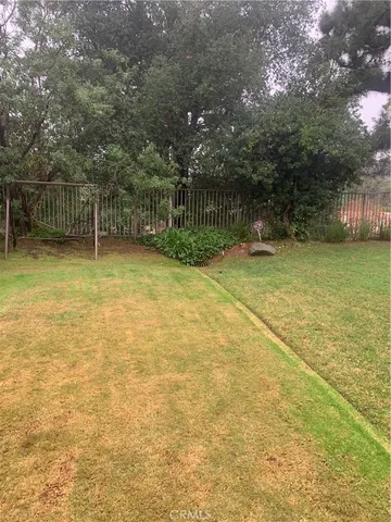 a backyard of a house with lots of green space and trees