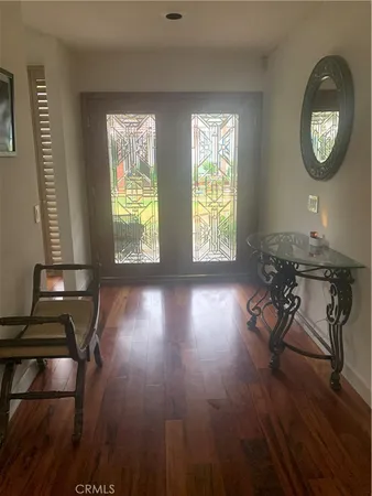 a view of a livingroom with furniture and hardwood floor