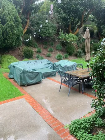 an outdoor sitting area with swimming pool and green space