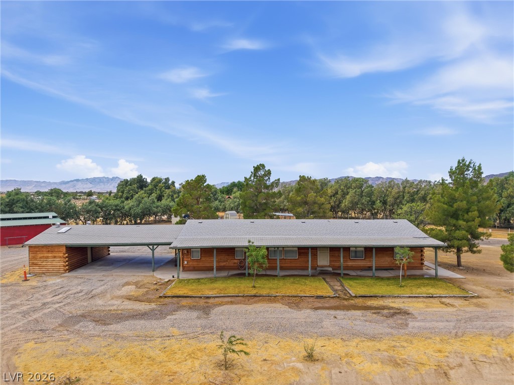 1531 West Harris Farm Road Pahrump, NV 89060 - Photo 1 of 37 A spacious log-cabin style home awaits, complete with an attached carport for convenient parking.