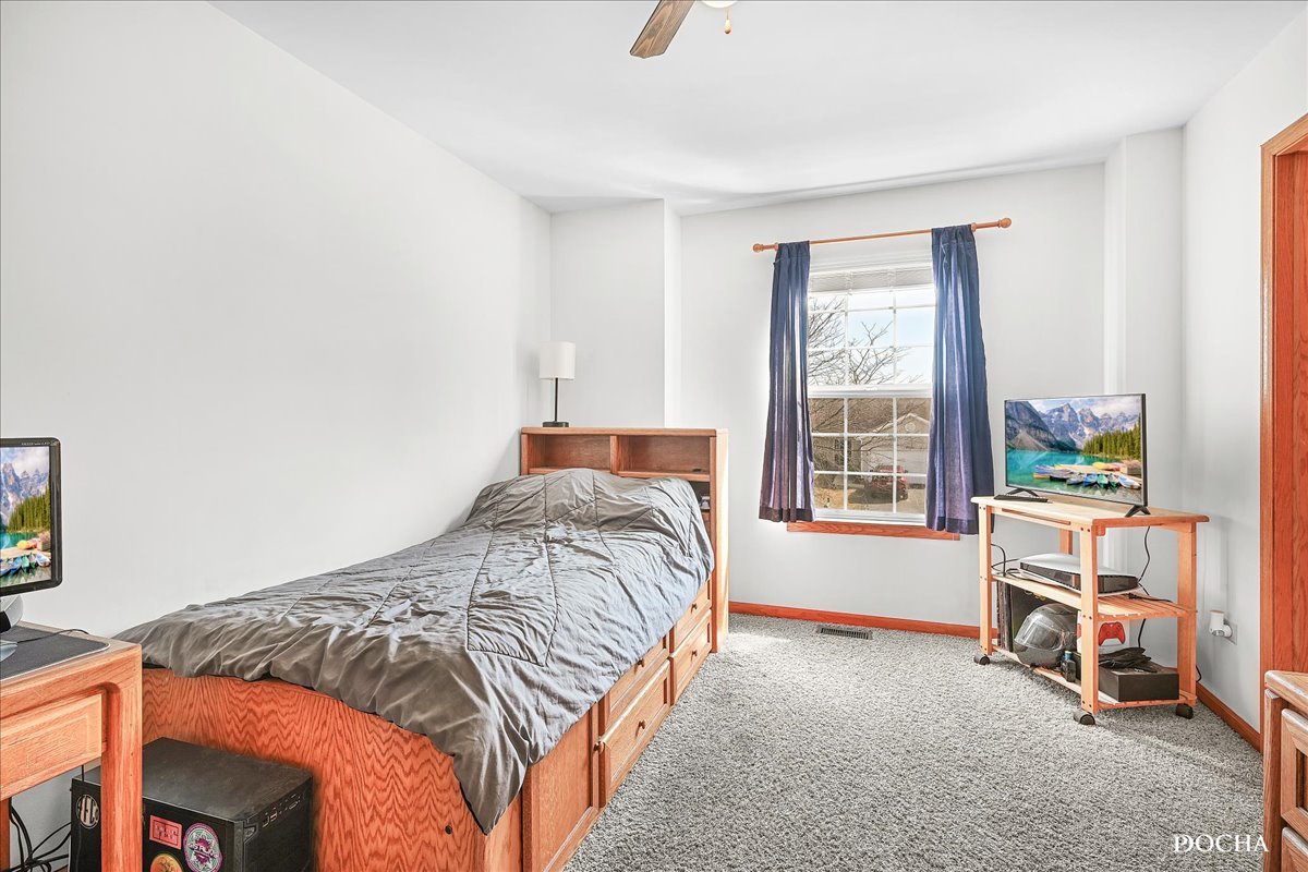 2209 Gray Hawk Drive Plainfield, IL 60586 - Photo 20 of 51 a bedroom with a bed and a window