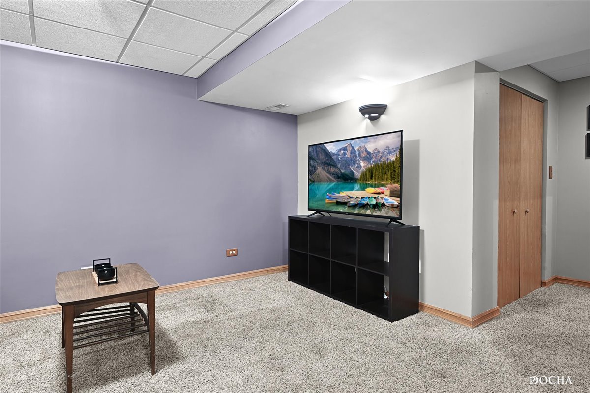 2209 Gray Hawk Drive Plainfield, IL 60586 - Photo 25 of 51 a room with furniture and a flat screen tv